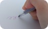 作ったペンで字を書いている写真