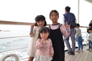 船の上で写真を撮る子ども