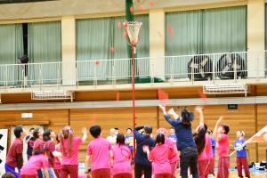 赤い玉を網に向かって投げる生徒たち