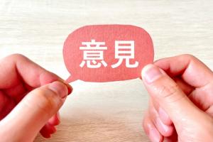 意見と書かれた紙をもっている写真