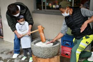 お父さんと一緒にもちをつく男の子