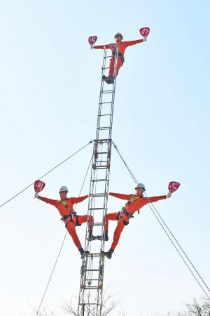 梯子の上で技を披露する3人の消防職員