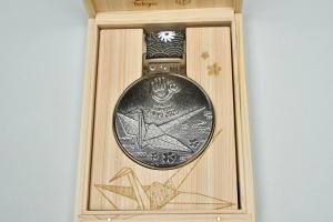 折り鶴が描かれた銀メダル