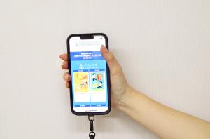 手に握られたスマートフォンの画面に映る電子図書館