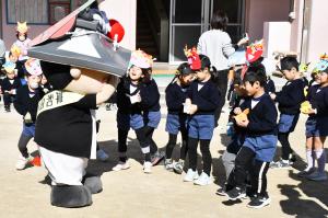 鬼のお面をつけたちきりくんに豆をぶつける園児たち