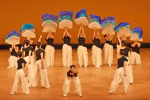 大きな扇子で水色の布をなびかせるパフォーマンス