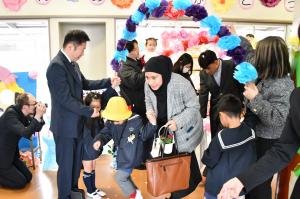 花飾りのアーケードを通る親子