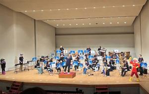 ステージ上の岸和田市音楽団とアンパンマンとバイキンマン