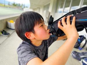 水筒を飲んでいる子どもの写真
