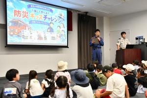 スクリーンを使い説明する司会の消防隊員
